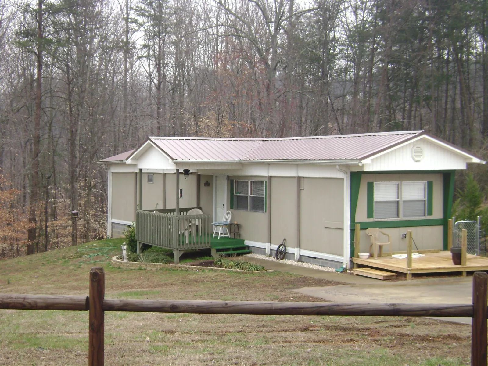 Mauve metal roof on a manufactured home with a new front deck in Foster